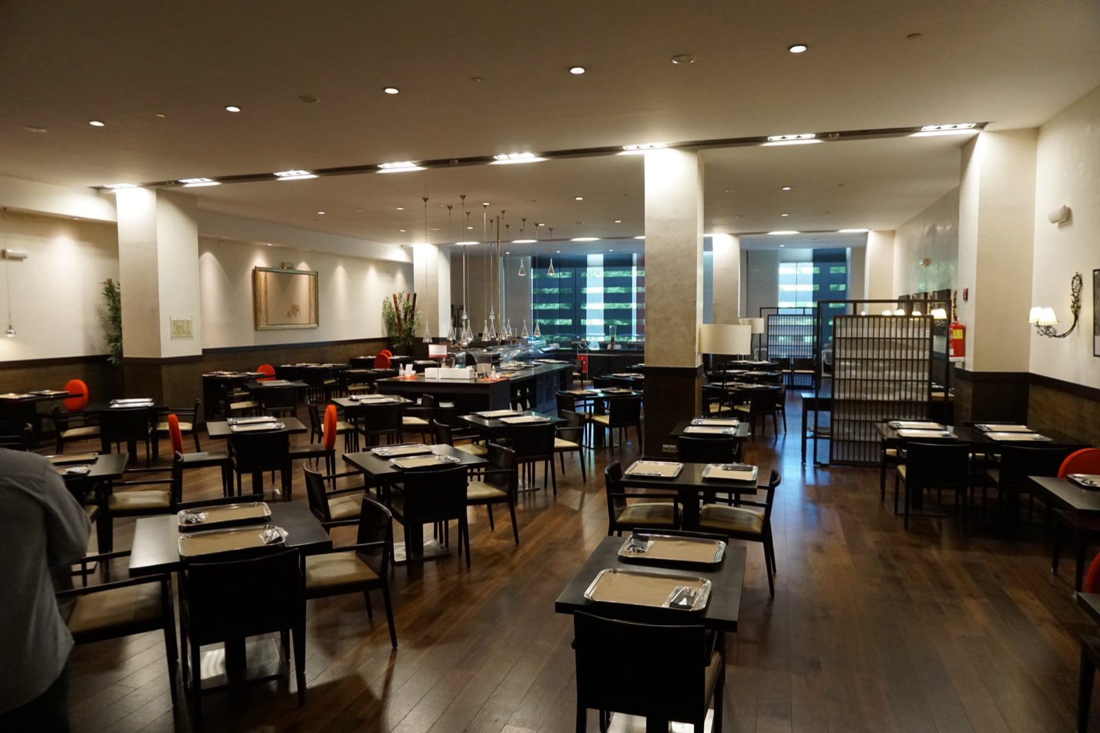 A bright dining room with rows of tables and chairs